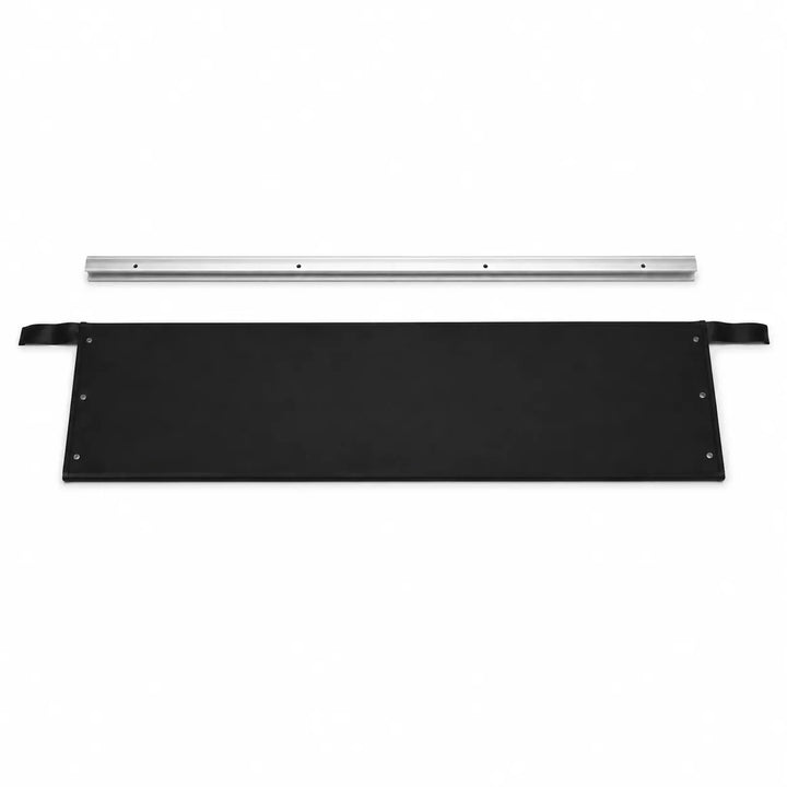 A black rectangular panel with metal grommets and a strap on one side, shown below a long silver metal rail on a plain white background.