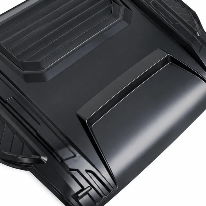 A close-up of a black molded plastic accessory, likely a protective cover or panel, showing its textured, ribbed design against a white background.