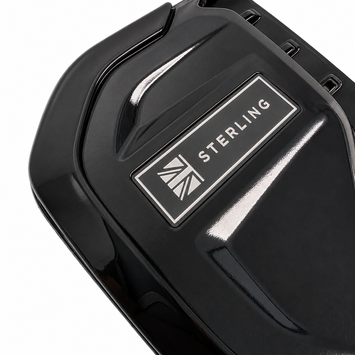 Close-up of a glossy black side vent with a rectangular silver badge reading STERLING and a small Union Jack logo, on a white background.