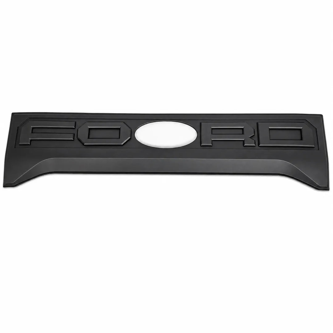 A black textured Ford emblem badge with raised lettering and a central oval cutout, shown on a plain white background.