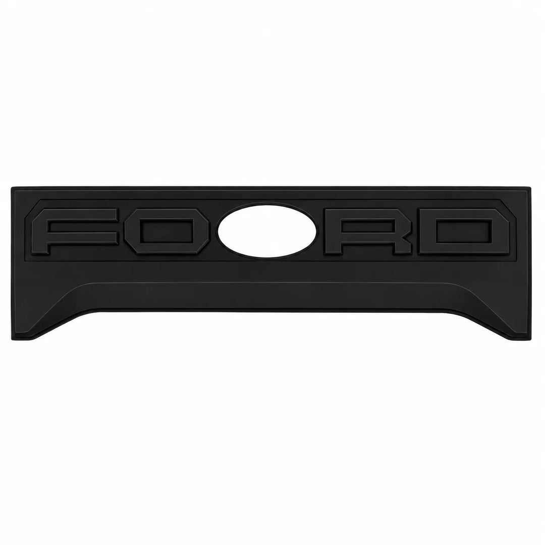 A black rectangular Ford emblem plate with the word 'FORD' embossed across it and a circular cutout in the center, shown on a plain white background.