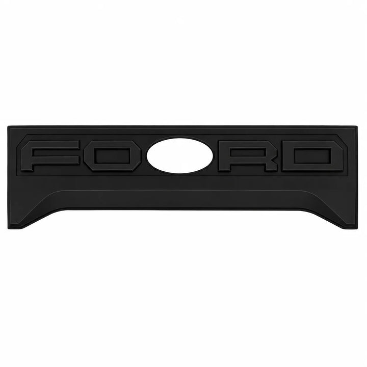 A black rectangular Ford emblem plate with the word 'FORD' embossed across it and a circular cutout in the center, shown on a plain white background.