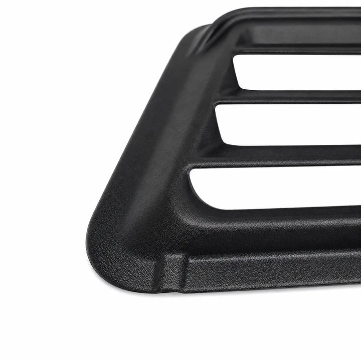 Close-up of a black textured plastic or metal grille insert with three horizontal slots, shown on a plain white background.