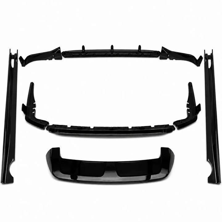 A set of glossy black automotive body trim pieces, including side skirt molds, a front splitter lip, and a lower trim valance diffuser bar, black spoiler wing arranged on a plain white background.
