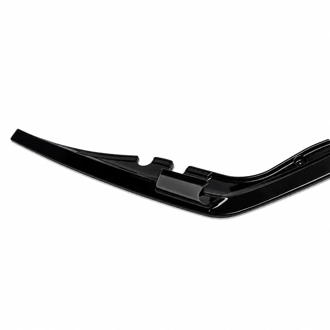 A glossy black automotive bumper lip or trim piece, shown from a side profile view against a plain white background.