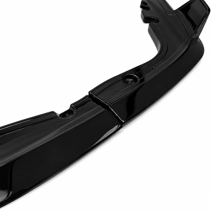 A glossy black automotive bumper lip or lower bumper trim piece shown on a clean white background.