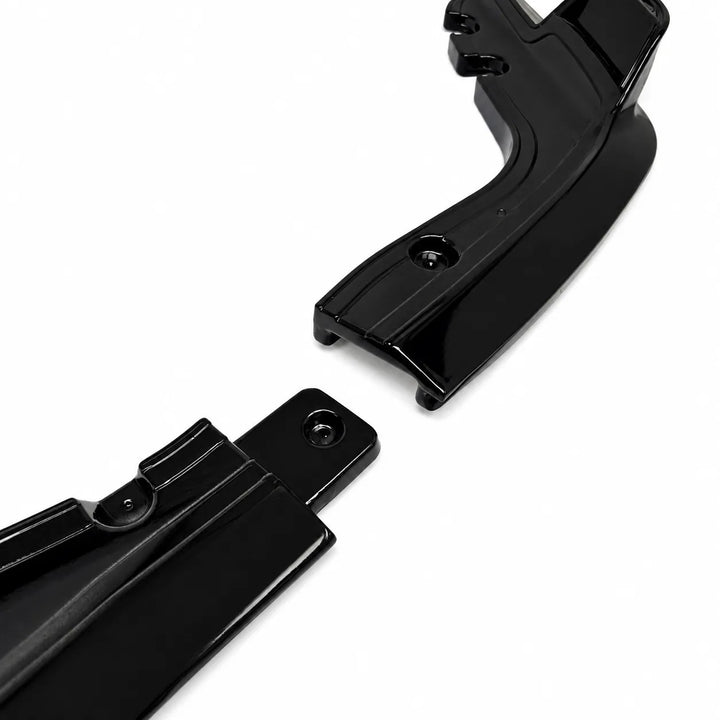 Two glossy black plastic automotive or motorcycle handlebar clip brackets shown on a clean white background.