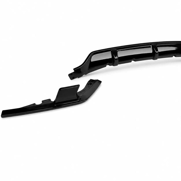 A pair of glossy black automotive body trim pieces, likely front splitter or lip spoiler components, displayed on a clean white background.