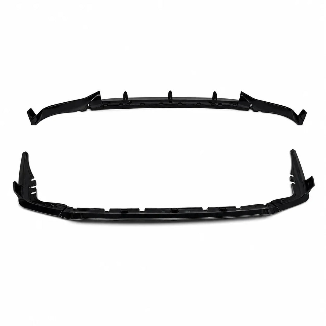 A pair of black plastic automotive bumper lip trim and rear diffuser pieces, shown from the front and rear angles on a solid white background.