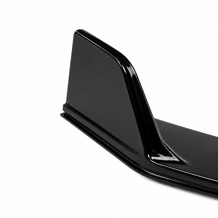A glossy black automotive front splitter spoiler wing detail, shown from a side angle against a plain white background.