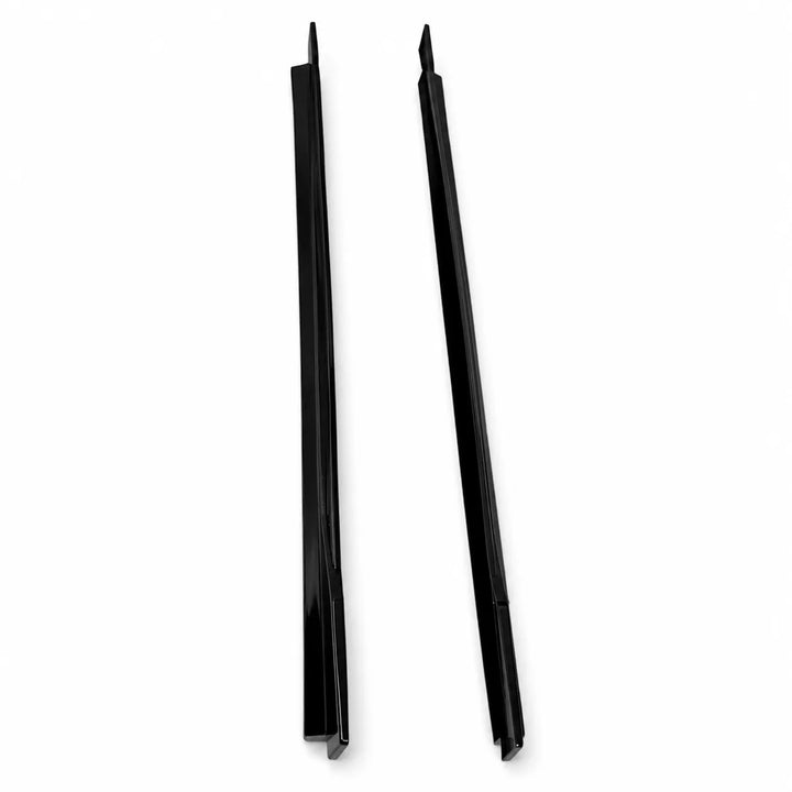 Two long, narrow black plastic or metal strips with angled tips, photographed standing upright on a plain white surface.